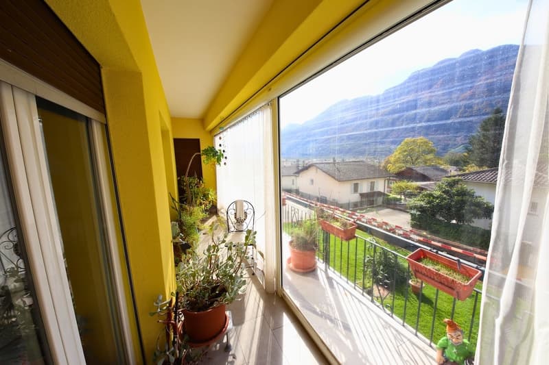 yellow walls, tiled floor, metal railing, plants, garden views