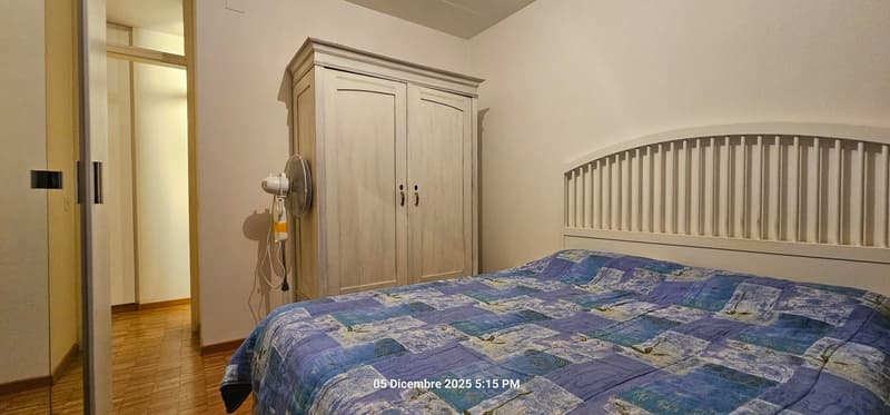 double bed, wooden flooring, wall cabinet, bed headboard, fan, watermark at the bottom
