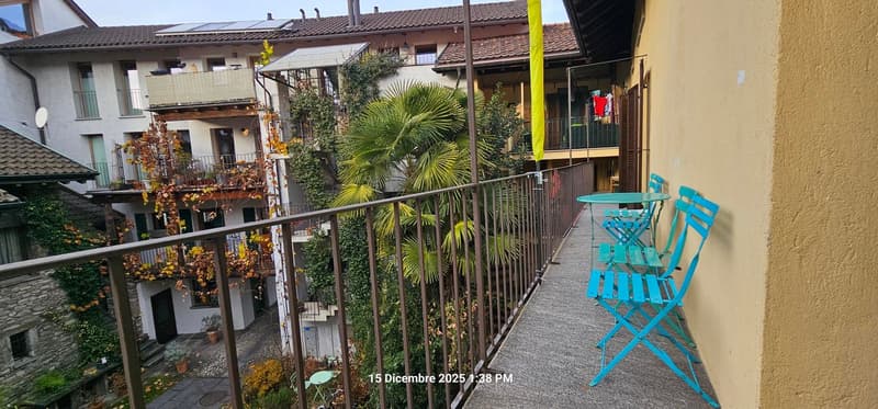 Metal railing, wooden floor, table and chairs