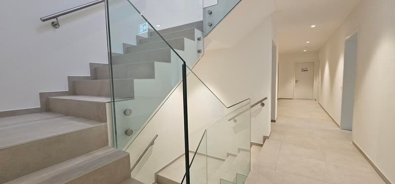 modern and stylish double flight of stairs with clear glass handrail and silver finish