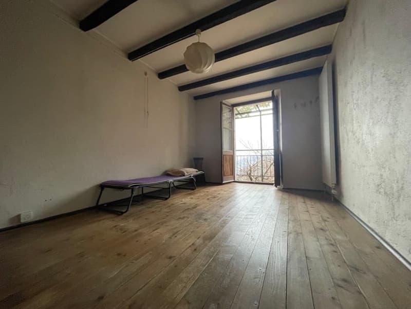empty room, wooden floor, open door, balcony, wooden beams on ceiling