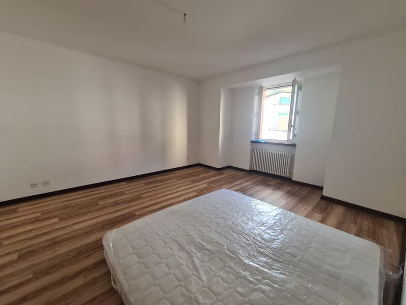 empty room, hardwood floor, white walls, a window, white sheet