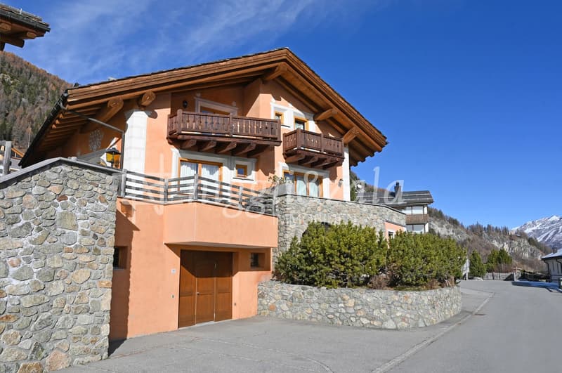 2 story house, wooden roof, stone wall, wooden balcony, wooden garage door