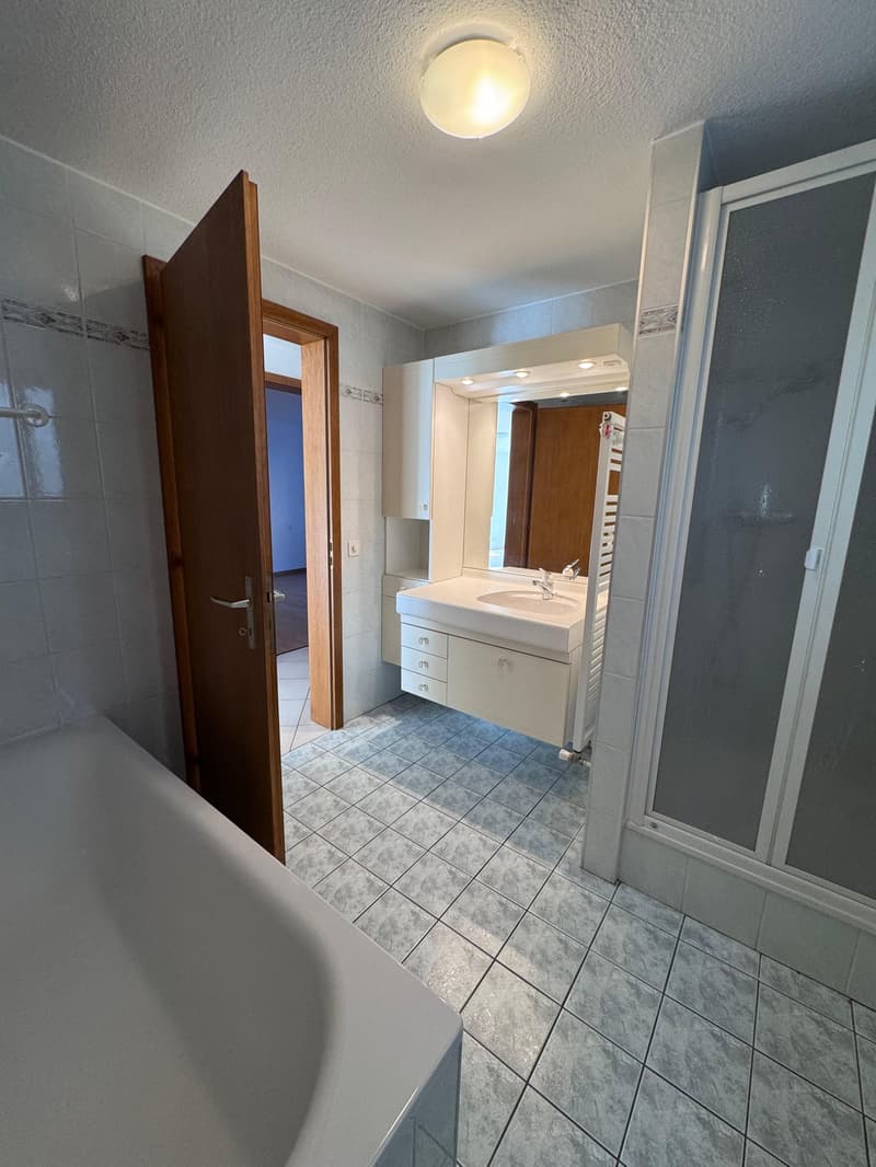 Bathroom: white tiled floor, white bathtub, white sink, mirror, shower