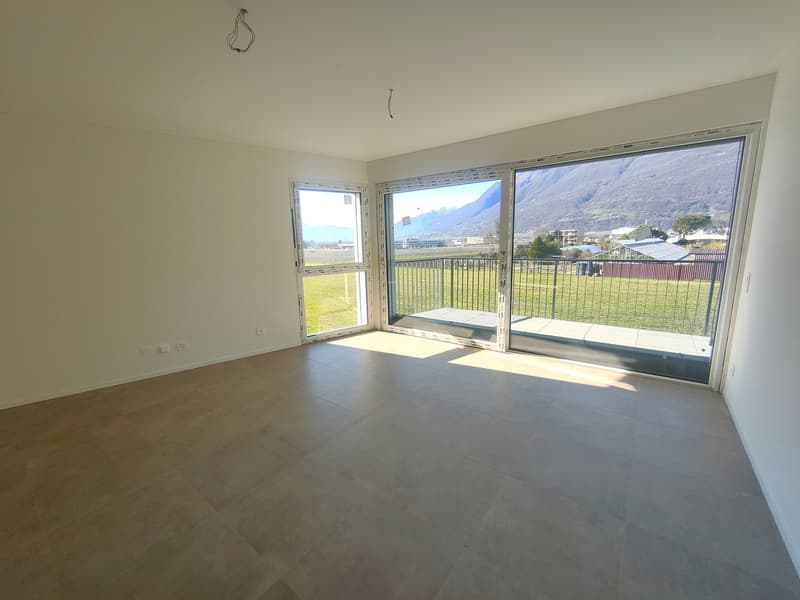 empty room, tiled floor, white walls, large glass doors with balcony, power outlets