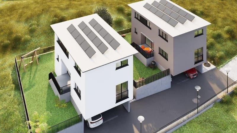 Two modern, multi-story white houses with slanted roofs and balconies, surrounded by a grassy area and a paved driveway with a parked car.