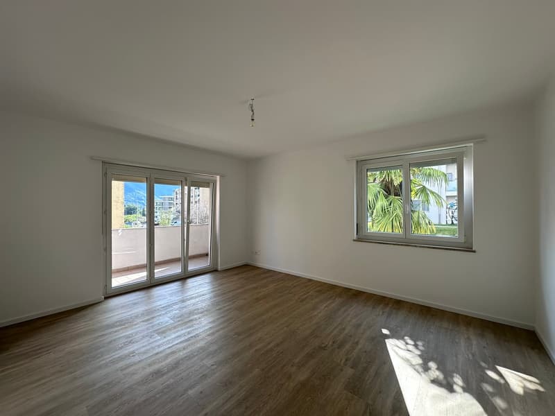 empty room, wooden floor, sliding glass doors, large windows, balcony, view of the outside