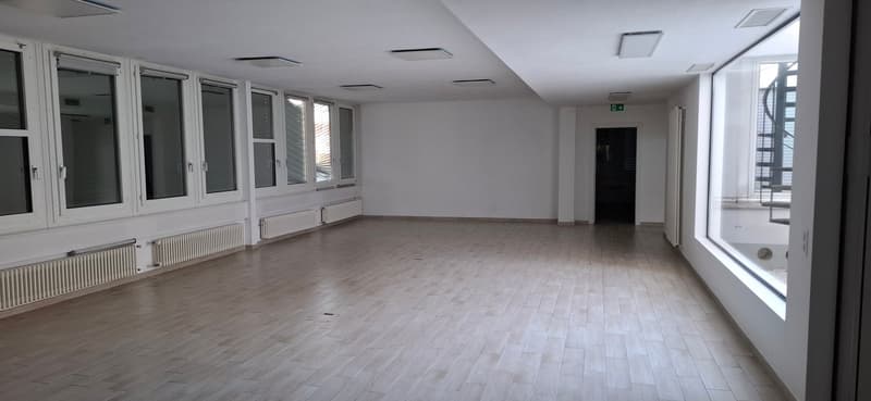 large windows, tiled floor, white walls, central heating radiators