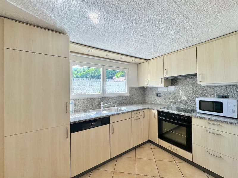 kitchen island, sink, dishwasher, gas stove, oven, microwave, wooden cabinets, tiled floor