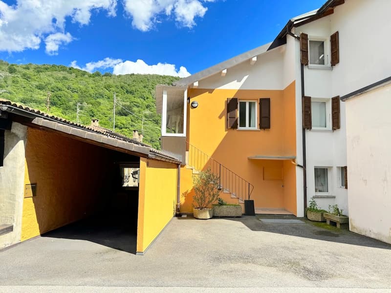 two story house, yellow and white exterior, garage entrance, stairs leading to front entrance