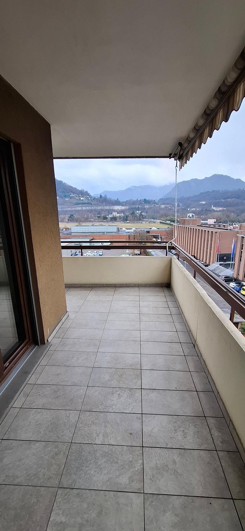 tiled balcony, glass railing, tile floor, wide view, empty