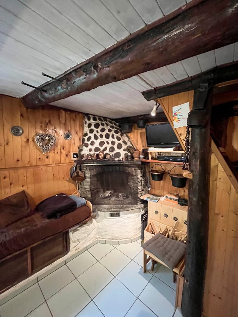 wooden walls, fireplace, built-in sofa, tile floor, wooden chair, tv, wooden storage