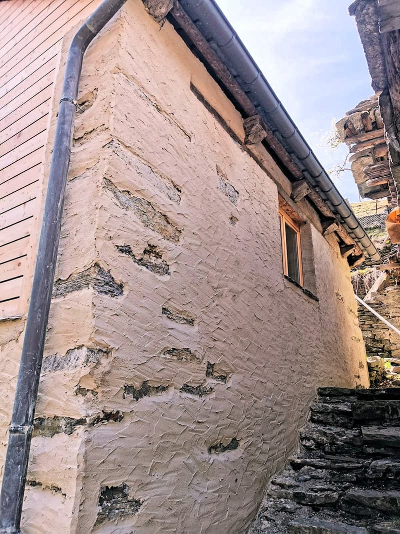 Stone wall, metal pipe, wooden beam, small window, stone stairs
