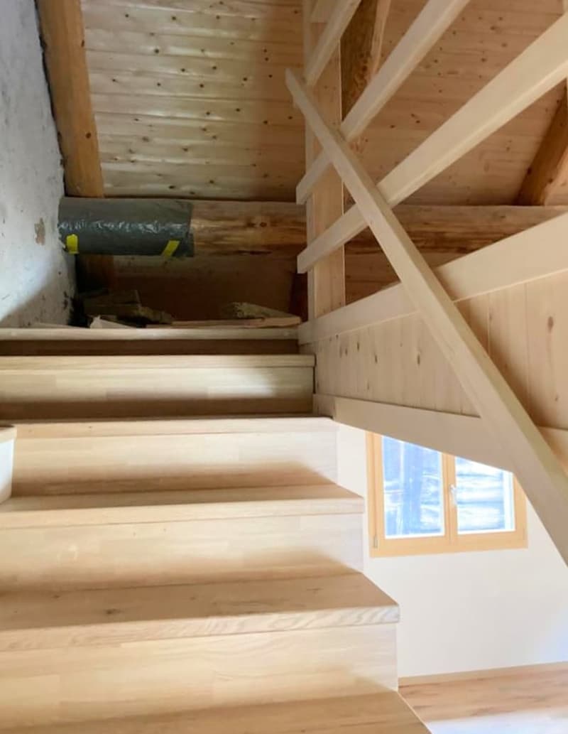 wooden staircase, wooden ceiling, white painted walls, wooden railing, window