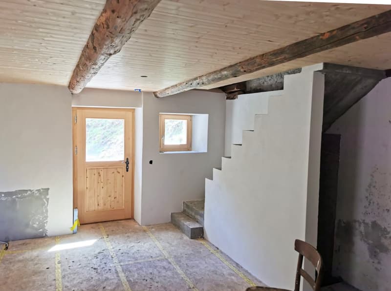 empty room, wooden door, window, wooden chair, unfinished walls, wooden beams