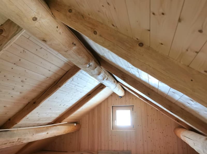 Wooden ceiling beams, wooden walls, attic window