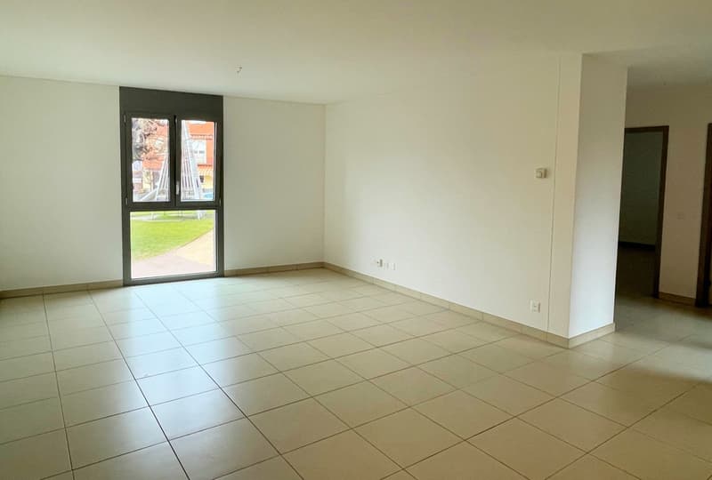 empty room with sliding glass door, white tiles, white walls