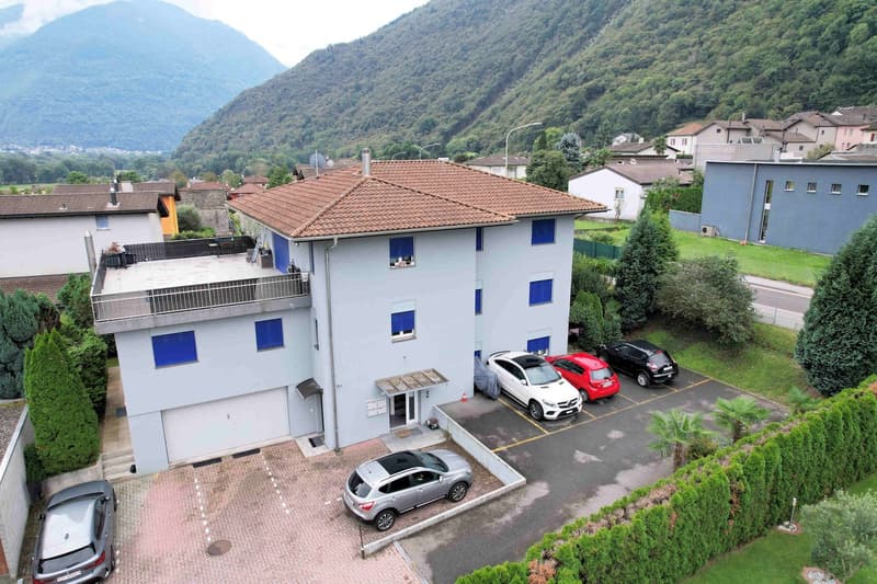 4 cars parked, balcony, garage, red tiled roof, 4 bedrooms