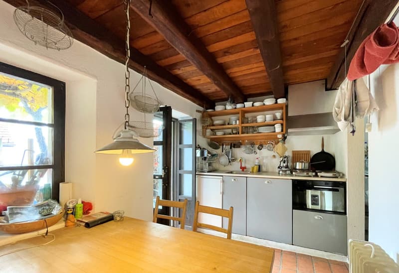 kitchen with wooden ceiling, a large window, and a large wooden table