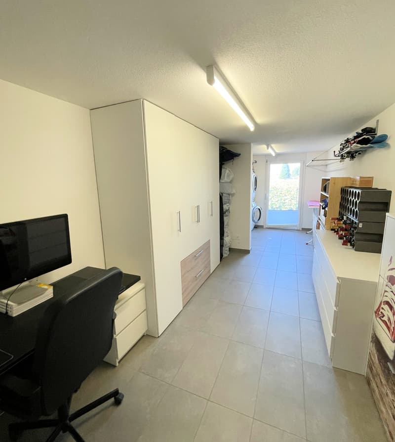 desk, chair, monitor, cabinet, washing machine, wine rack, storage boxes, clothes rack