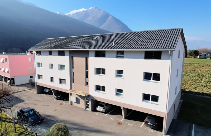 3 story apartment building, white exterior, multiple windows, underground parking, mountain view
