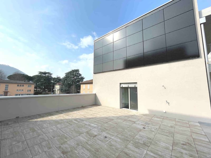 modern building with solar panels, tiled terrace, glass doors, white walls