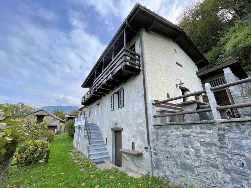 2 story house, stone wall, balcony, stairs, door, lamp