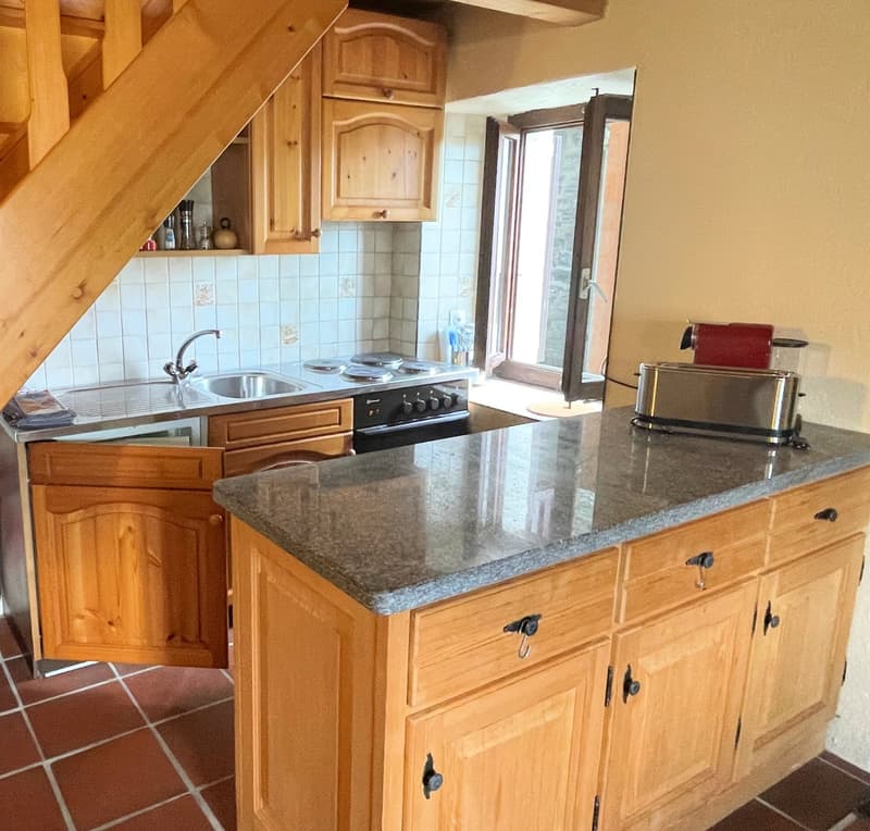 kitchen with granite countertop, wooden cabinets, sink, stove, toaster, open window