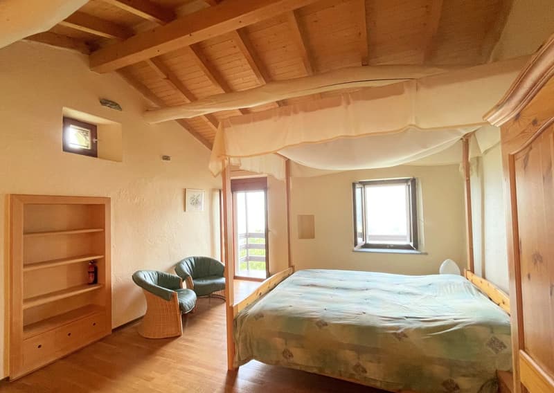 wooden bed with canopy, wooden chairs, wooden shelf, windows, wooden ceiling