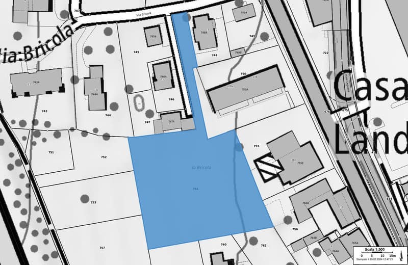 Plot of land with a blue shaded area indicating the property boundary, surrounded by other plots and streets.