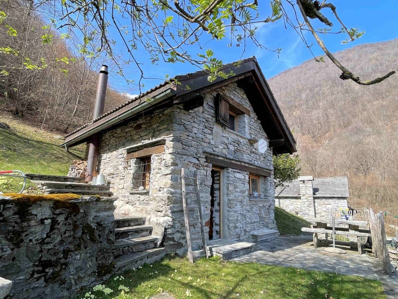 Stone house, wooden door, stone steps, wooden bench, chimney, mountain view