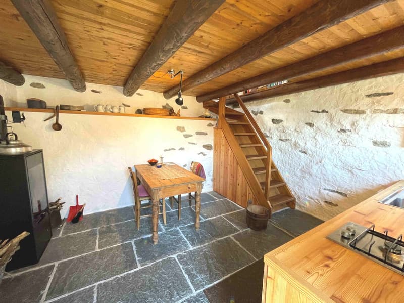wooden ceiling, wooden table, wooden stairs, white walls, fireplace