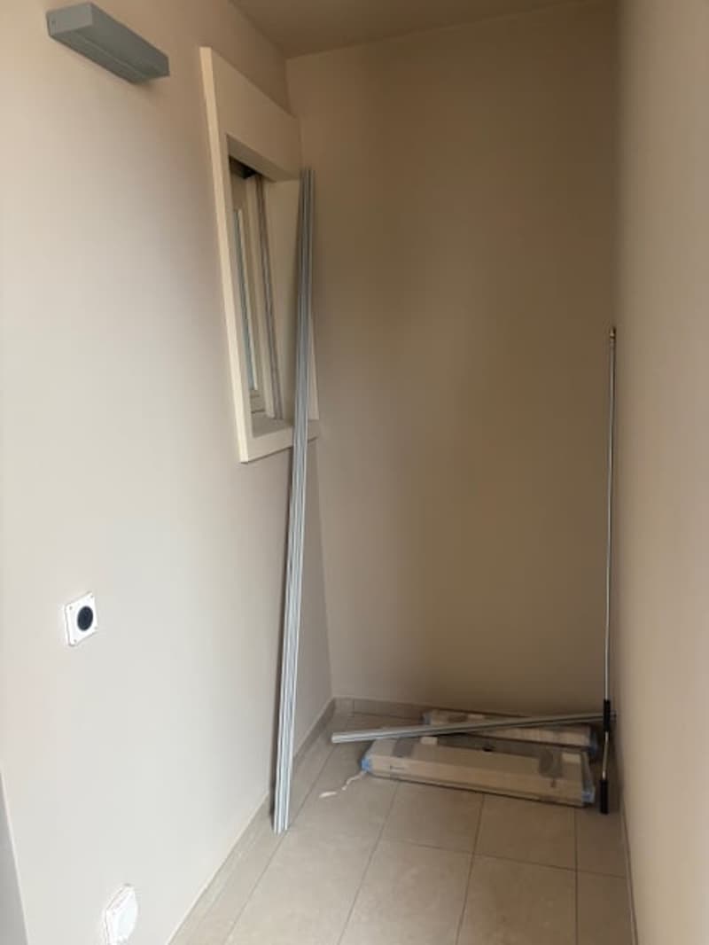 empty room, white walls, tiled floor, open window, wall lamp, power outlet