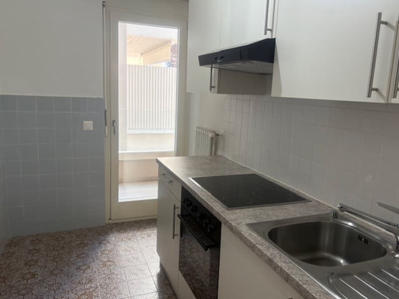 kitchen with white cabinets, tiled floor, stainless steel sink, black stove, oven, dishwasher, window with blinds