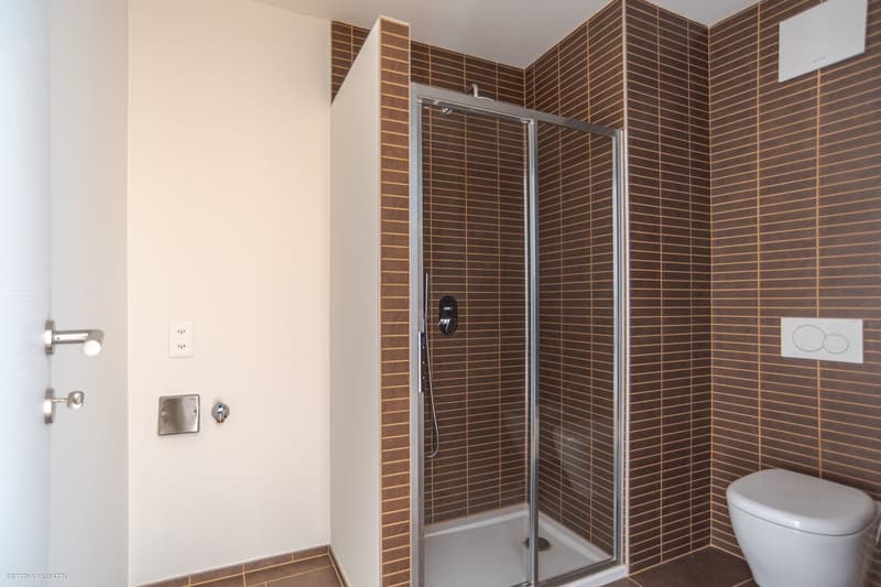 compact bathroom with shower and toilet
