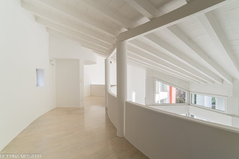 open space, spiral staircase, balcony, high ceilings, wooden floors