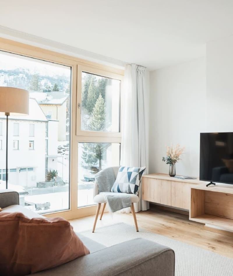 double sofa, wooden chair, desk with TV, large glass windows, floor lamp, floor with carpet