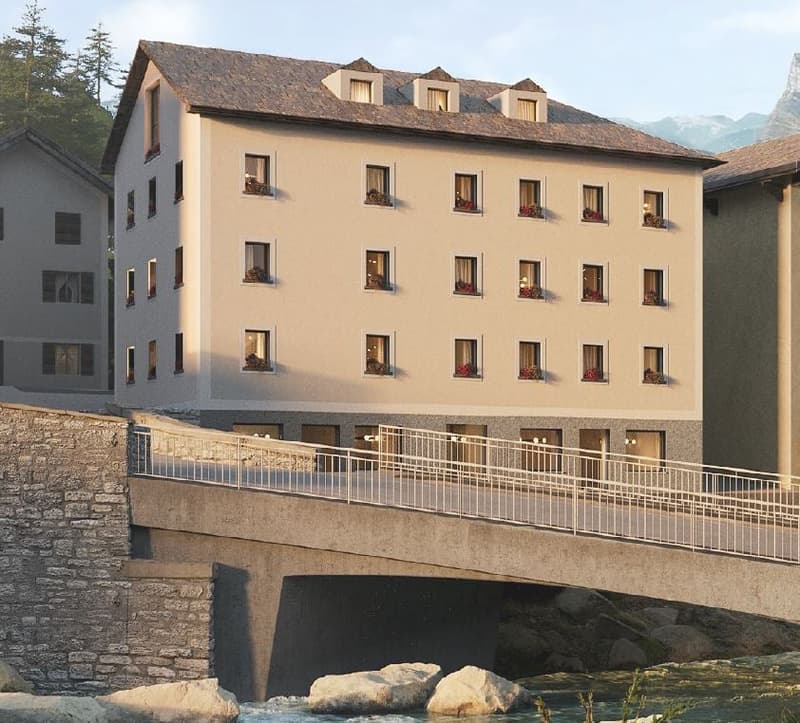 A multi-story building, balconies, mountain view