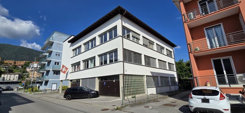 3 storey building with 3 garages. Swiss flag on wall