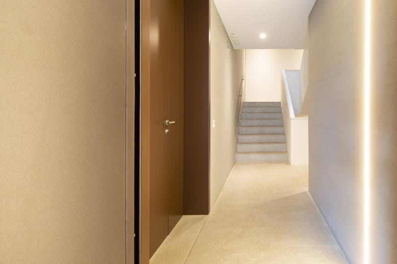 tiled floor, brown door, white walls, staircase