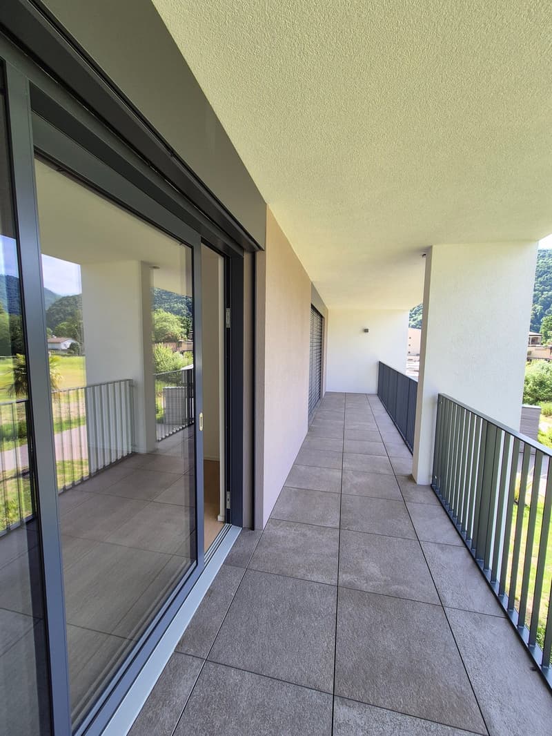 glass sliding door, tiled floor, metal railings, balcony