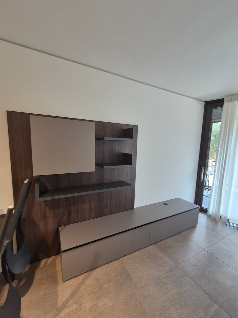 wooden built-in shelves, bench with drawers, tile floor, balcony with railing, glass door, white curtains