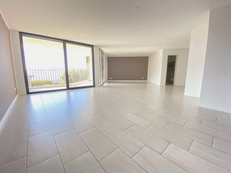 large room, white tiles, sliding glass doors, balcony