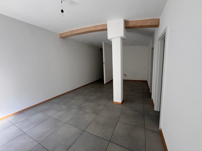 empty room, white walls, gray tiles, wooden beam, white pillar, two doors