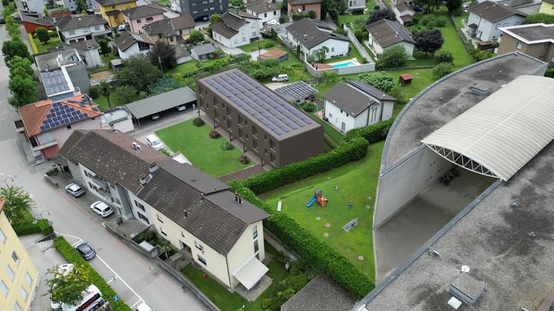 Aerial view of a residential area with several houses, solar panels on roofs, a swimming pool, and a playground.