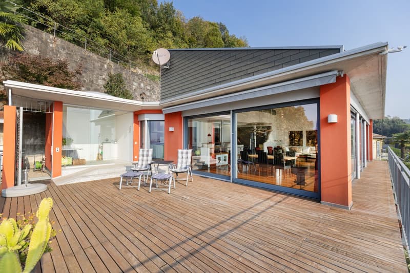 modern architecture, large glass windows, wooden terrace, orange walls, satellite dish