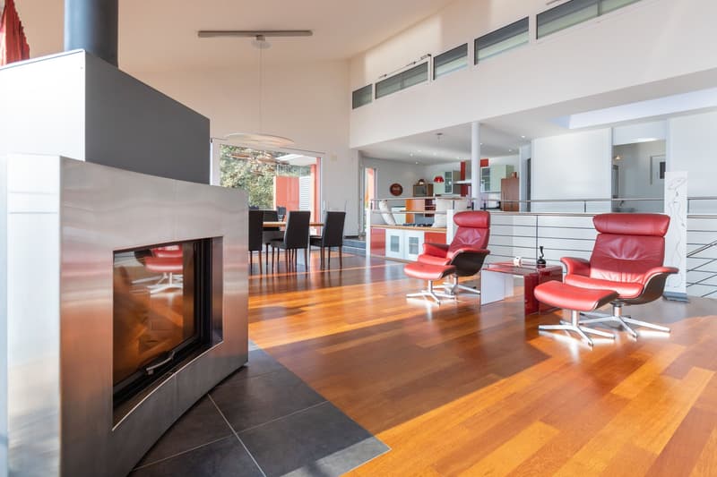 modern fireplace, wooden floor, red chairs, white ceiling, metal staircase