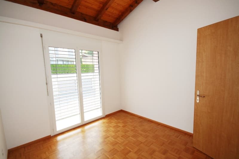 white walls, wooden floor, glass sliding doors, balcony