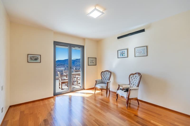 wooden floor, sliding glass door, balcony, chairs, picture frames, ceiling light