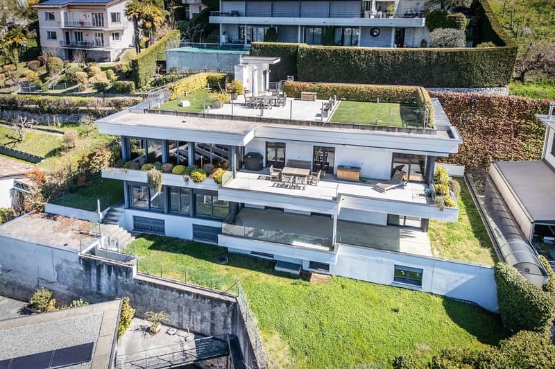 Modern house, multiple levels, large windows, green roof, swimming pool, balcony, outdoor dining area, garden, view of surrounding area
